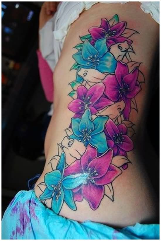 Colorful Blue And Pink Orchid Flowers Tattoo On Side Rib