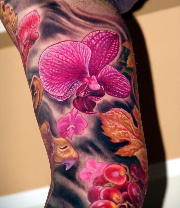 Colorful Orchid Flowers Tattoo On Inner Bicep
