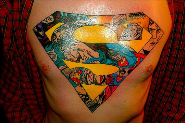 Colorful Superman Logo Geek Tattoo On Man Chest