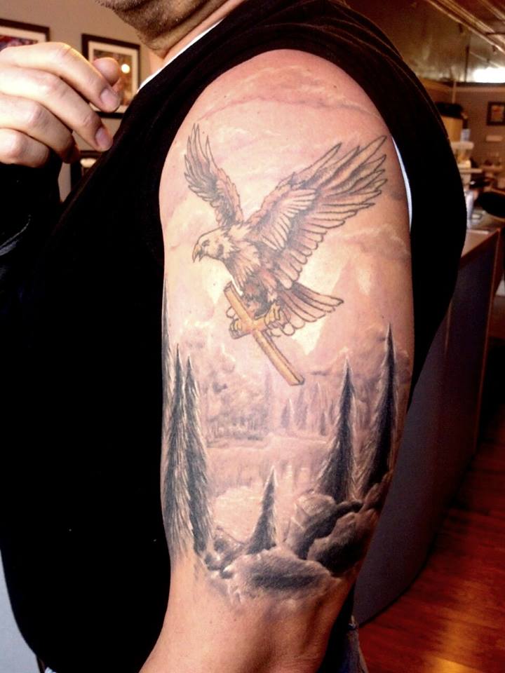 Cross In Flying Eagle Claw Scenery Tattoo On Man Left Half Sleeve