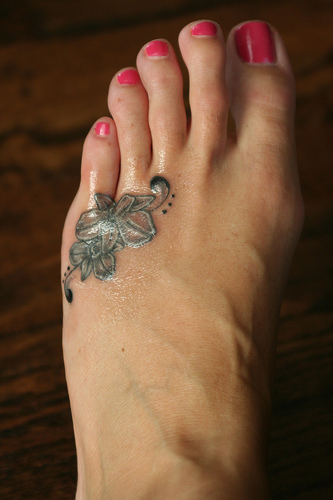 Cute Orchid Tattoo On Girl Left Foot