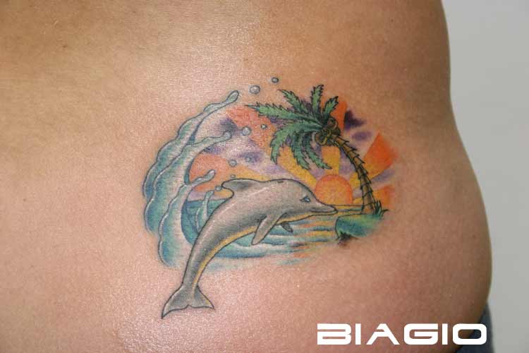 Dolphin Beach Scene Tattoo On Lower Back