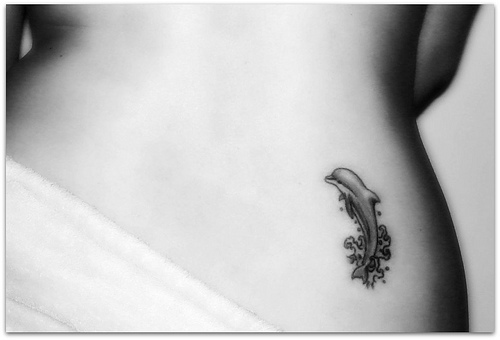 Dolphin Tattoo On Girl Lower Back