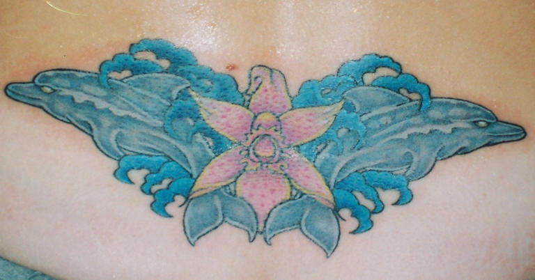 Flower And Dolphin Tattoos On Lower Back