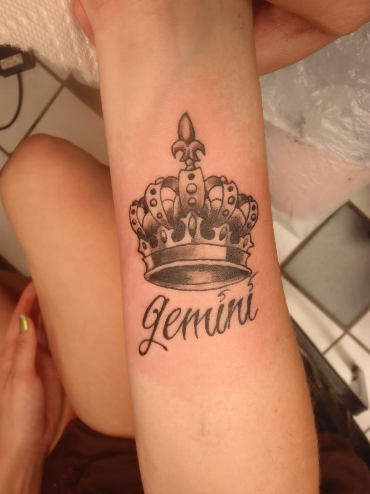 Gemini – Black Ink King Crown Tattoo On Forearm
