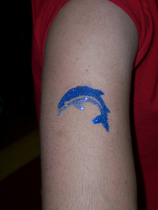 Glitter Blue Dolphin Tattoo On Bicep