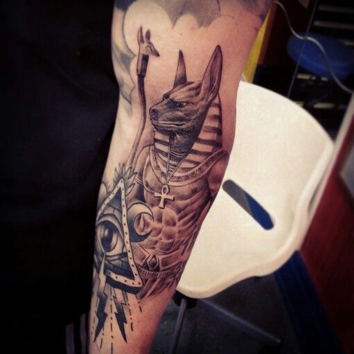 Grey Ink Anubis Tattoo On Left Sleeve