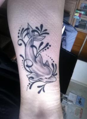 Grey Ink Dolphin Tattoo On Left Forearm
