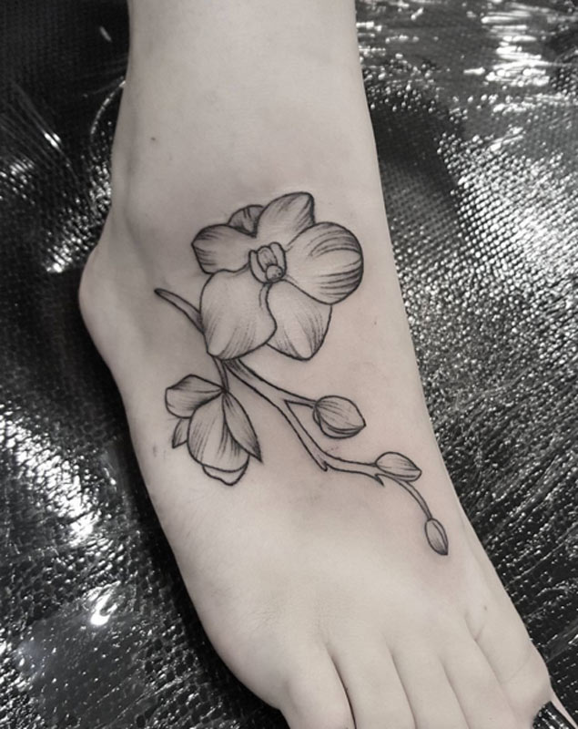 Grey Ink Orchid Flower Tattoo On Girl Right Foot by Elose Entraigues