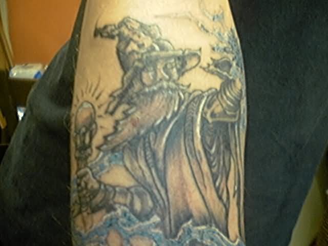 Grey Ink Wizard Tattoo On Biceps
