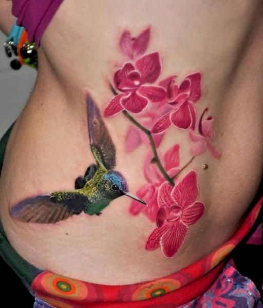 Hummingbird And Orchid Tattoos On Girl Side Rib