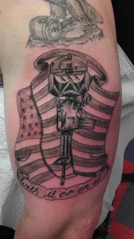 Memorial Military Equipments With Banner Tattoo On Half Sleeve