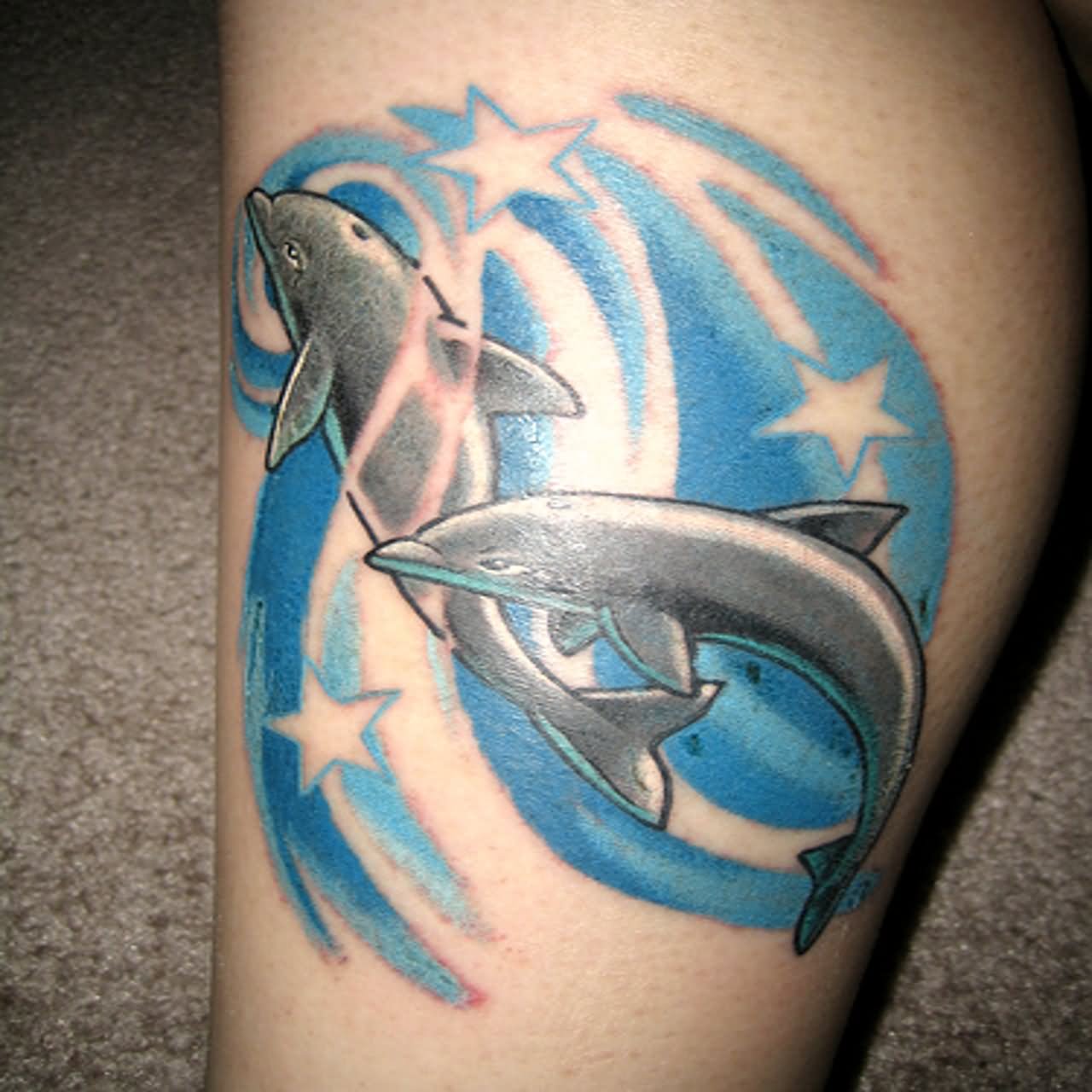 Nice Blue Stars And Dolphin Tattoo