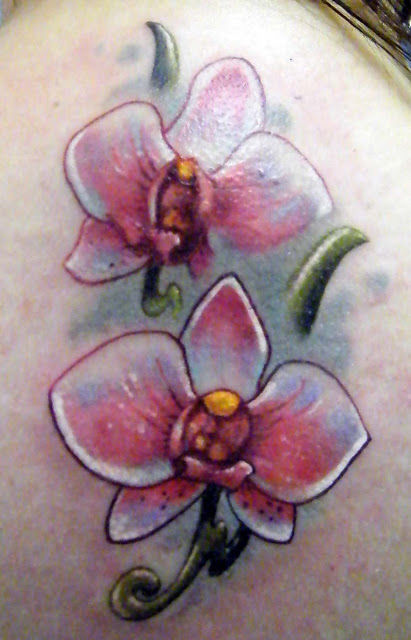 Nice Colored Orchid Tattoo On Left Shoulder