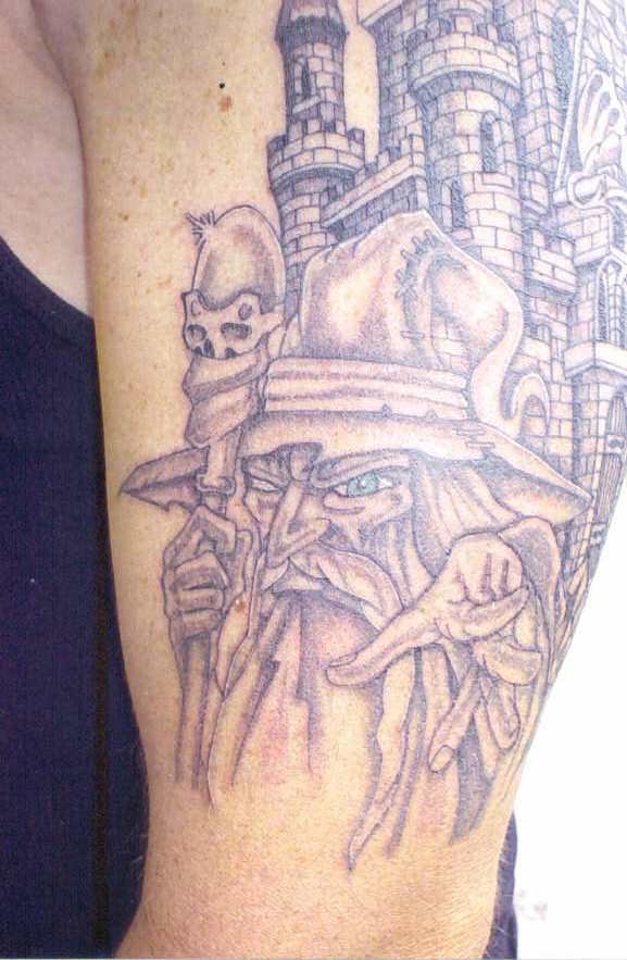 Nice Grey Ink Wizard And Castle Tattoo On Left Bicep