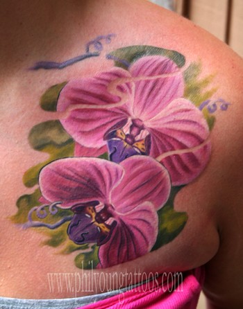 Orchid Tattoo On Woman Front Shoulder by Twistedmentality