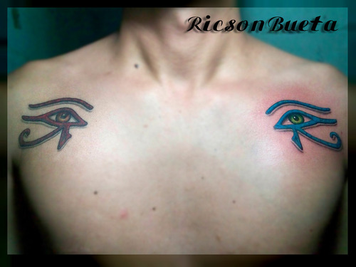 Red And Blue Anubis Eye Tattoos On Both Shoulders