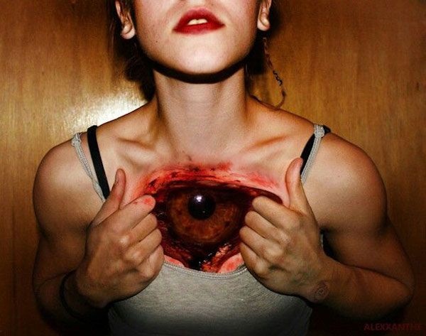 Red Ink Torn Ripped Skin Eye Tattoo On Girl Chest