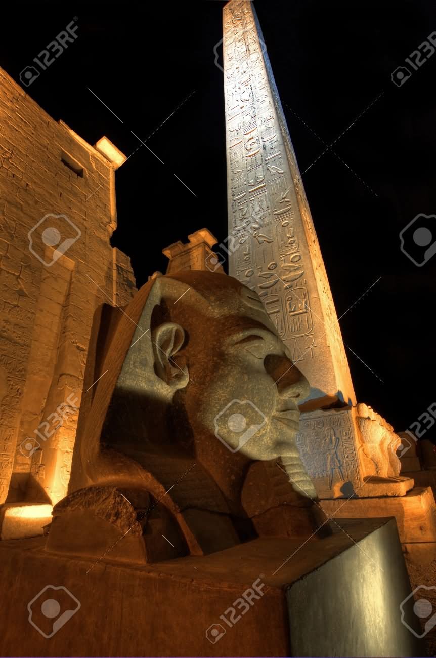 Statue Of Ramses II And Obelisk At The Entrance Of The Luxor Temple At Night