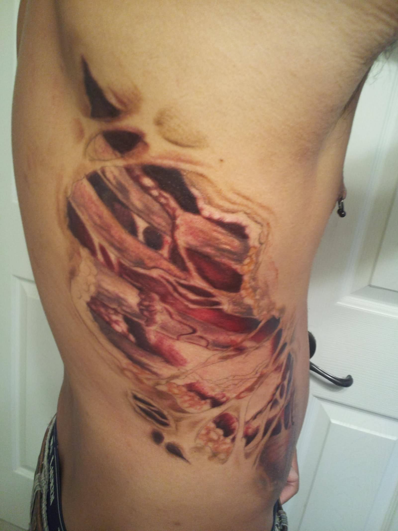 Torn Ripped Skin Rib Cage Tattoo On Man Side Rib