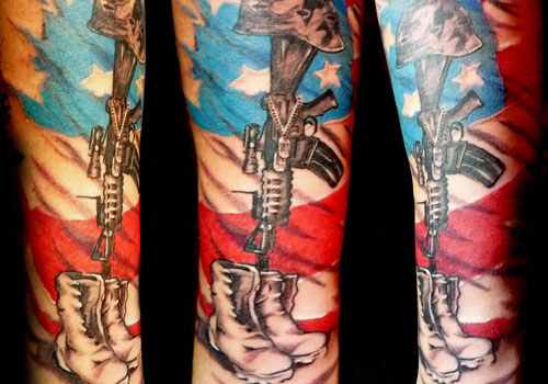 USA Flag With Military Equipments Tattoo On Sleeve