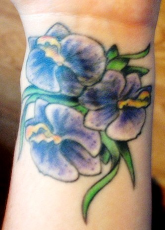 White And Blue Ink Orchid Tattoo On Wrist