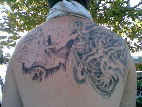 Wizard And Castle Tattoo On Upper Back