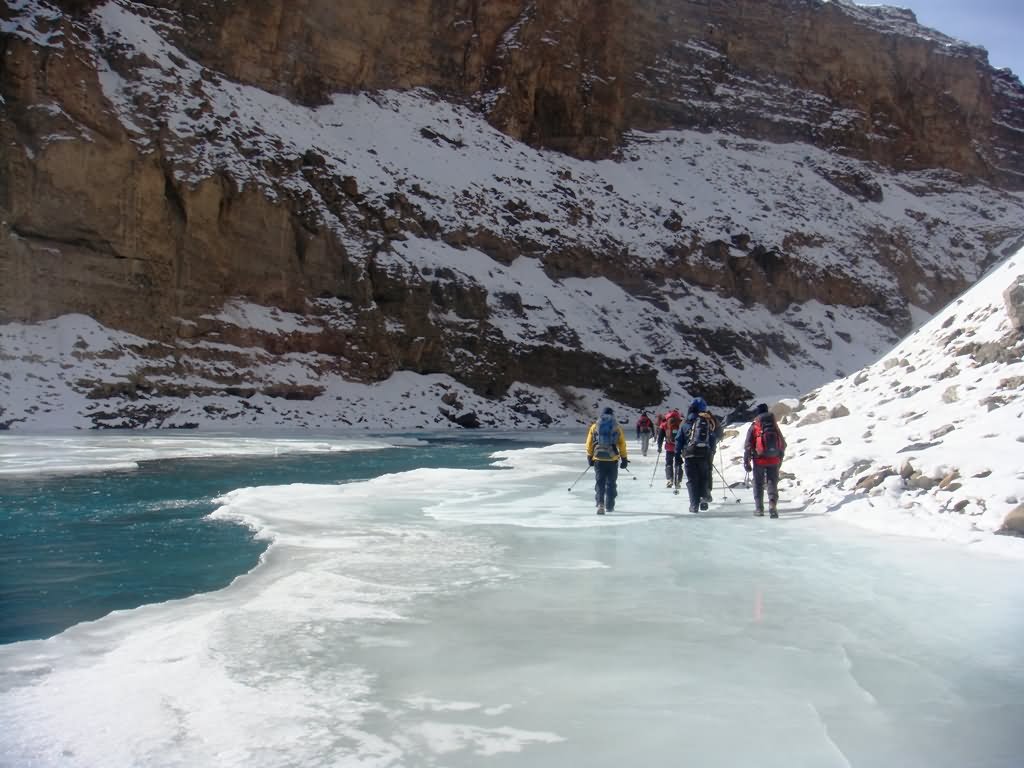 A Group Of Trekkers On The Frozen Zanksar River In Ladakh