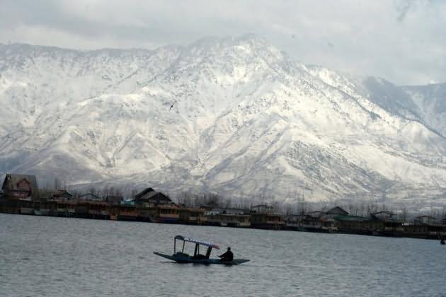 A View Of The Dal Lake Is Seen In Front Of Snow Covered Mountains
