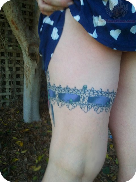 Beautiful Blue Ink Garter Tattoo On Girl Thigh