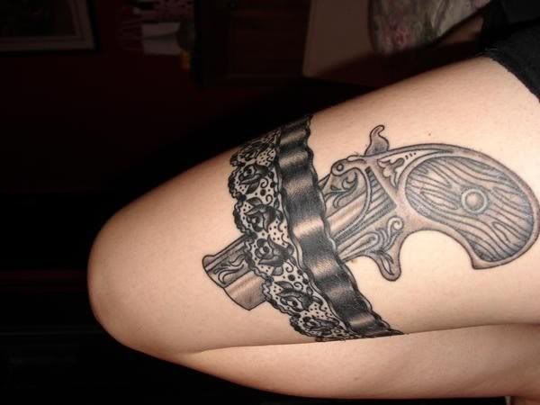 Black And Grey Country Garter Tattoo On Girl Thigh