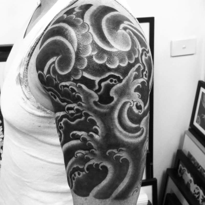 Black And Grey Wave Tattoo On Left Shoulder