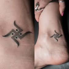 Black Jain Swastik Tattoo On Ankle