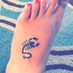 Black Little Scorpion Tattoo On Girl Foot
