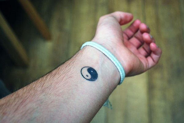 Black Yin Yang Symbol Tattoo On Man Left Wrist