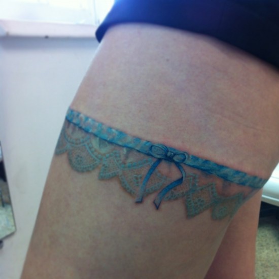 Blue Ink Lace Garter Tattoo On Thigh