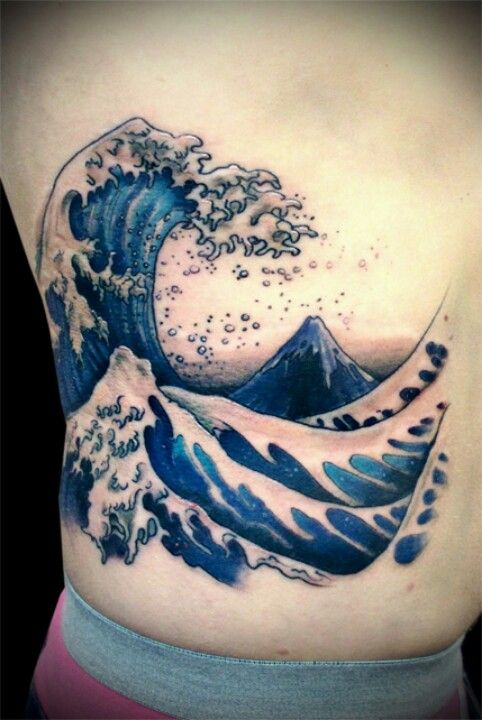 Blue Ink Ocean Wave Tattoo On Side Rib