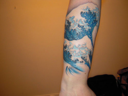 Blue Ink Wave Tattoo On Arm