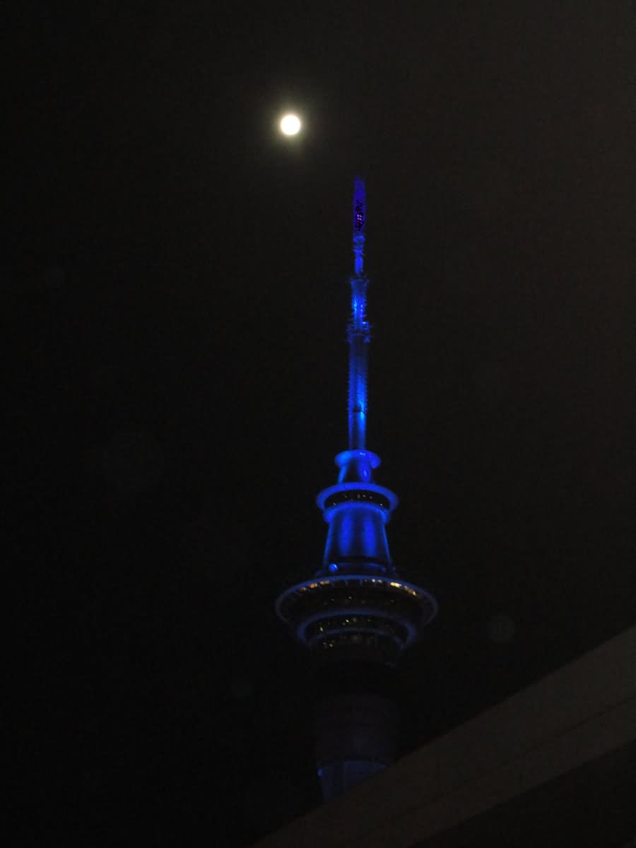 Blue Lights Sky Tower In Auckland With Full Moon