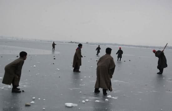 Children Playing At Frozen Dal Lake In Winter Season
