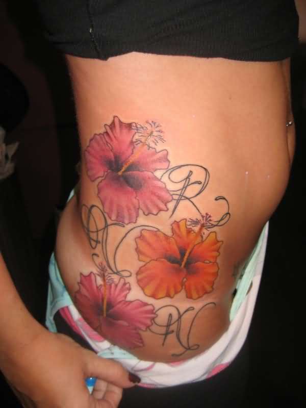 Colored Hibiscus Flowers Tattoos On Rib Side