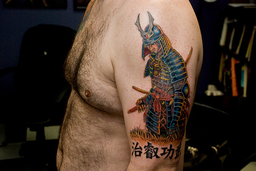 Colored Samurai Tattoo On Man Left Half Sleeve