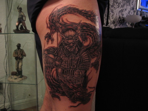 Grey Ink Dragon Samurai Tattoo On Thigh