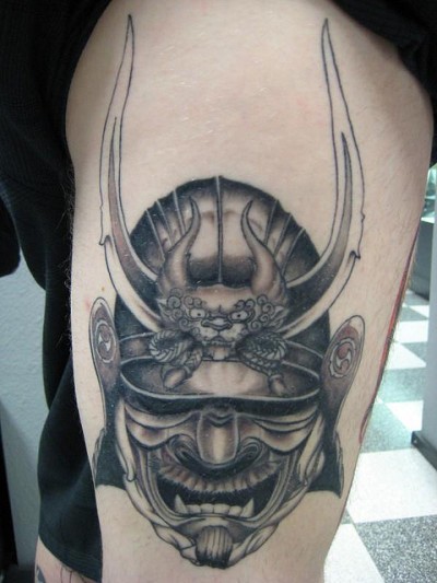 Grey Ink Samurai Head Tattoo On Leg
