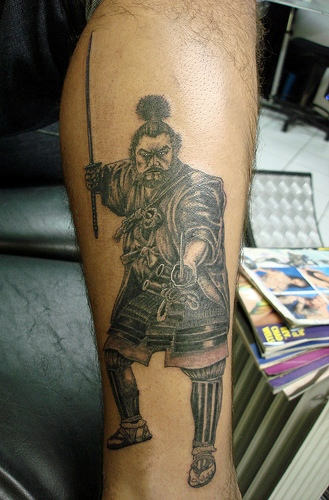 Grey Ink Samurai Tattoo On Leg