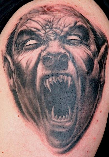 Grey Ink Vampire Face Tattoo Design