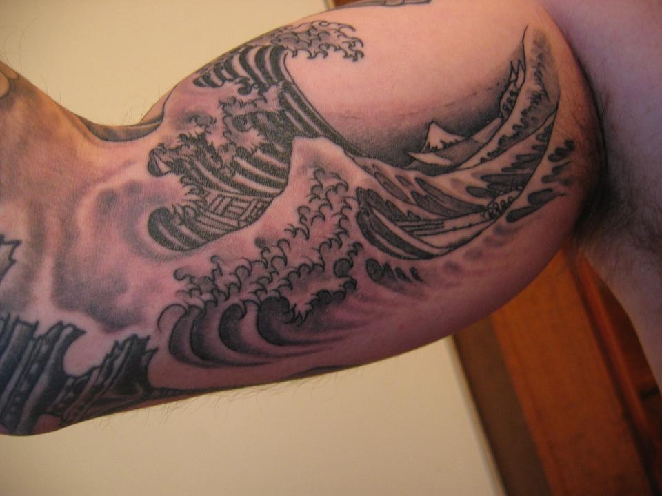 Grey Ink Wave Tattoo On Inner Bicep