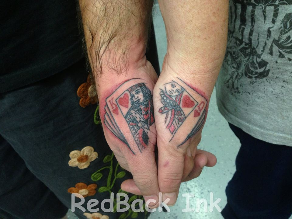 King And Queen Of Hearts Cards Tattoo On Couple Hand