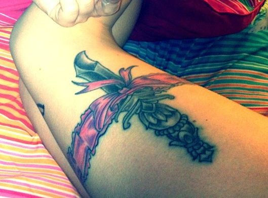 Lovely Dagger And Garter Tattoos On Thigh