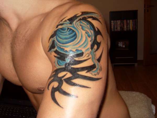 Man Left Shoulder Tribal Wave Tattoo